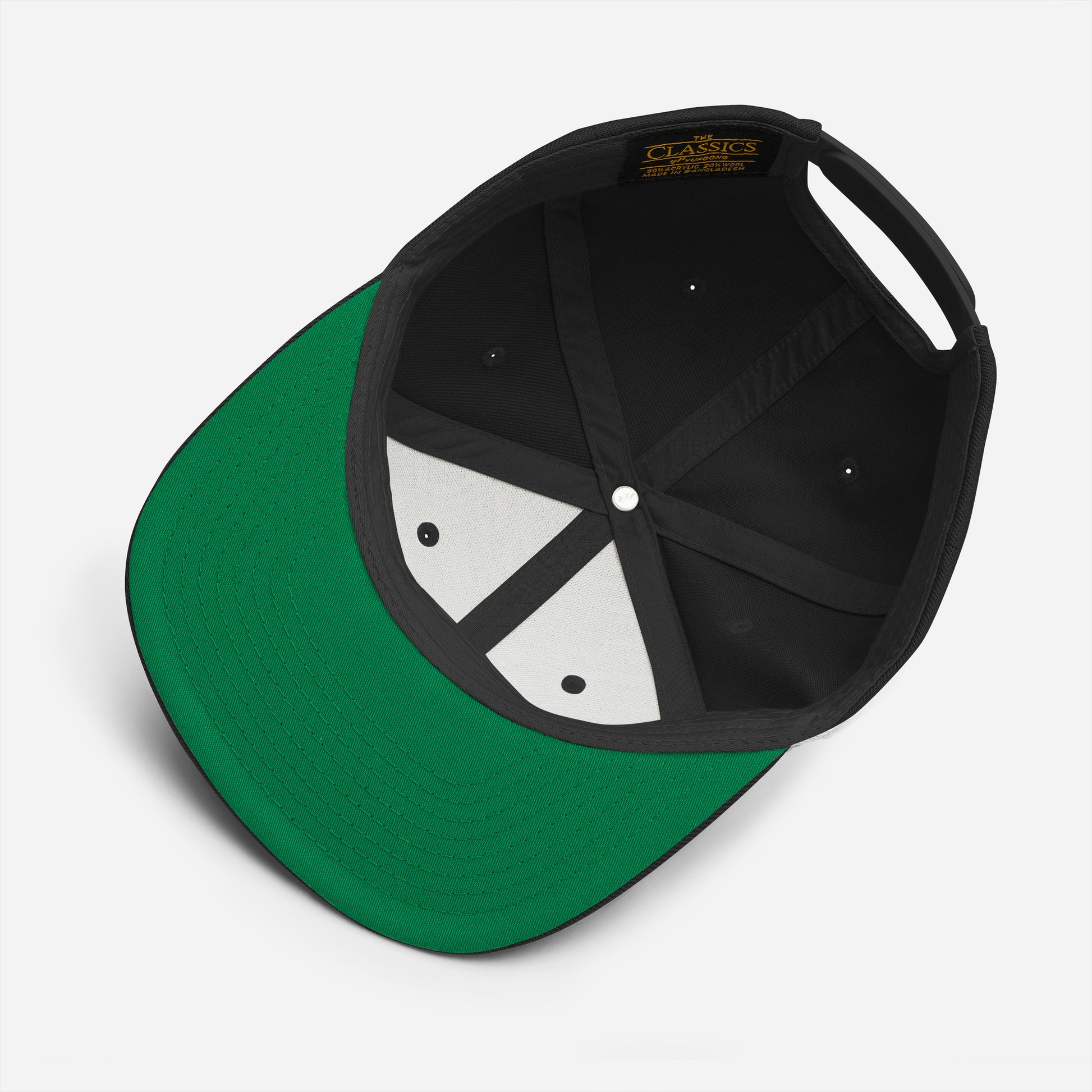 A close-up view of the Addicted2Cigars Embroidered Snapback Hat, showing its inside. The classic fit hat features a green brim, a white button at the top, and black lining with ventilation holes. The label inside reads "CLASSIC SNAPBACK ONE SIZE FITS ALL," highlighting its adjustable snap closure for a perfect fit.