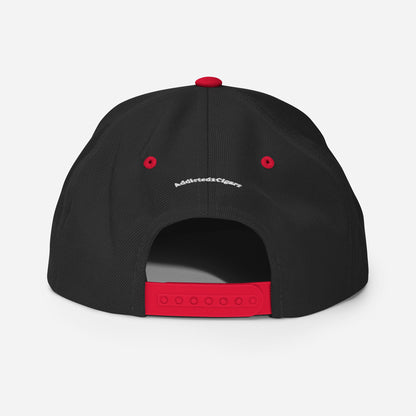 A black Addicted2Cigars Embroidered Snapback Hat displayed from the back, featuring a red adjustable strap and red button on top. Small white text is visible above the adjustable snap closure. The background is white.